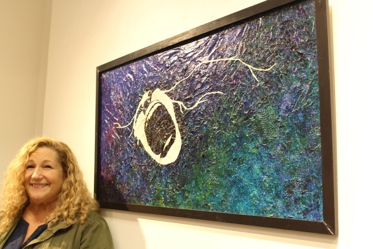 Bellport High School art teacher Lisa Carrano with her painting, “Romut.